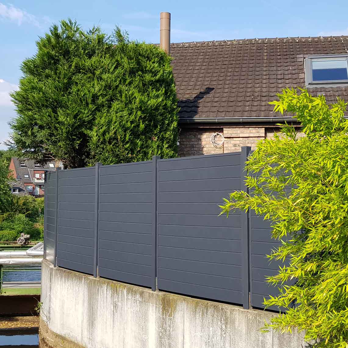 ECOLINE - modernes Anthrazit als lange Trennwand Sichtschutzwand in Anthrazit aus Kunststoff PVC im Garten auf Mauer