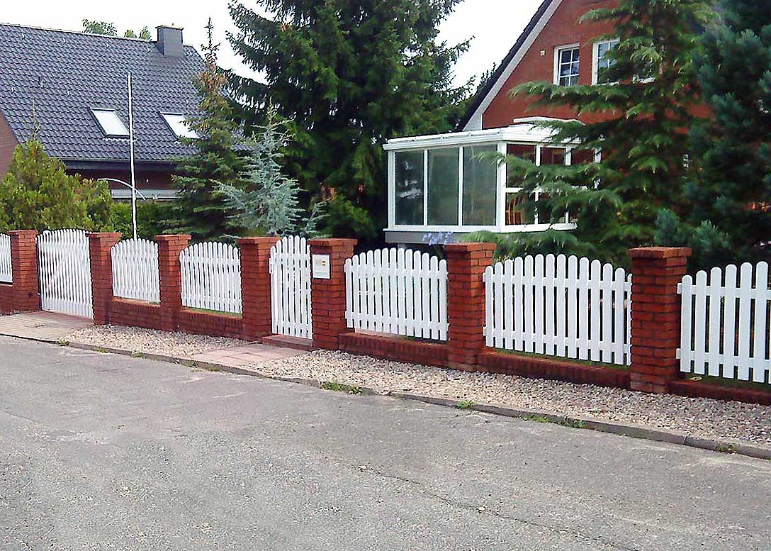 Weißer Lattenzaun mit Oberbogen – klassische Eleganz für stilvolle Grundstücksgrenzen